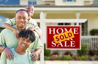 Family-In-Front-of-Real-Estate-Sign-and-House.jpg